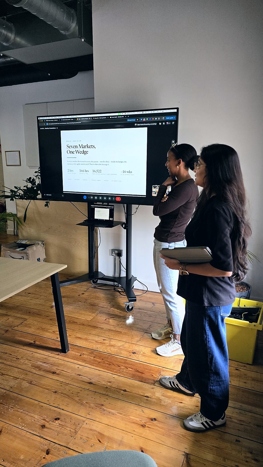 Two presenters at the screen